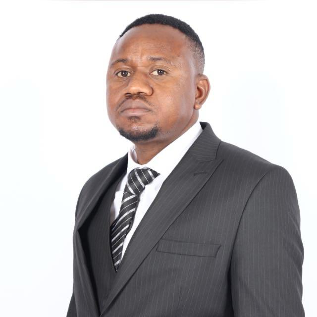 Studio portrait of Jabu Hanyani, founding director of Hanyani Attorneys Inc, in a charcoal pinstripe suit